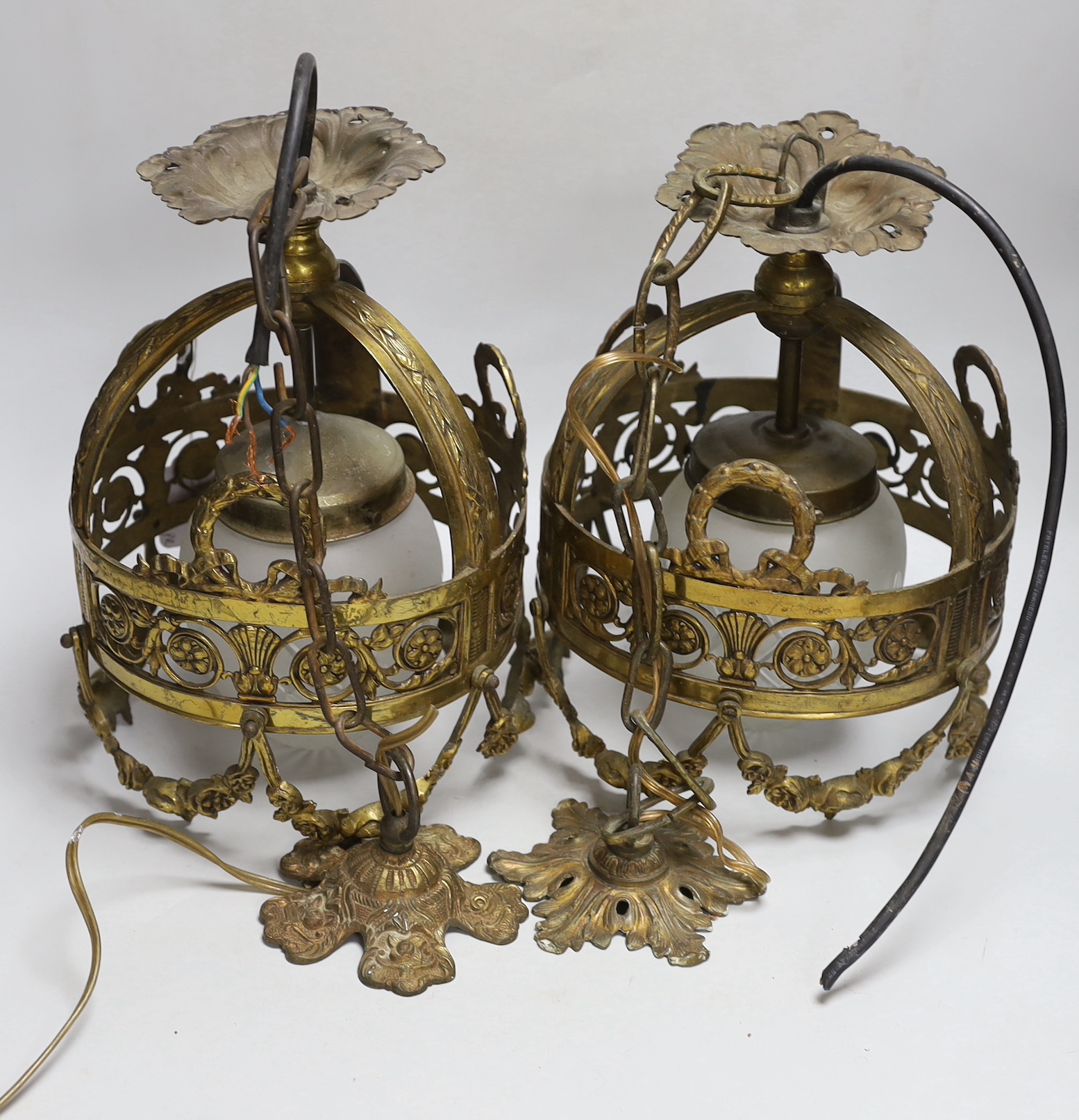 A pair of hanging lanterns with glass shades, 29cm high not including chain and rose